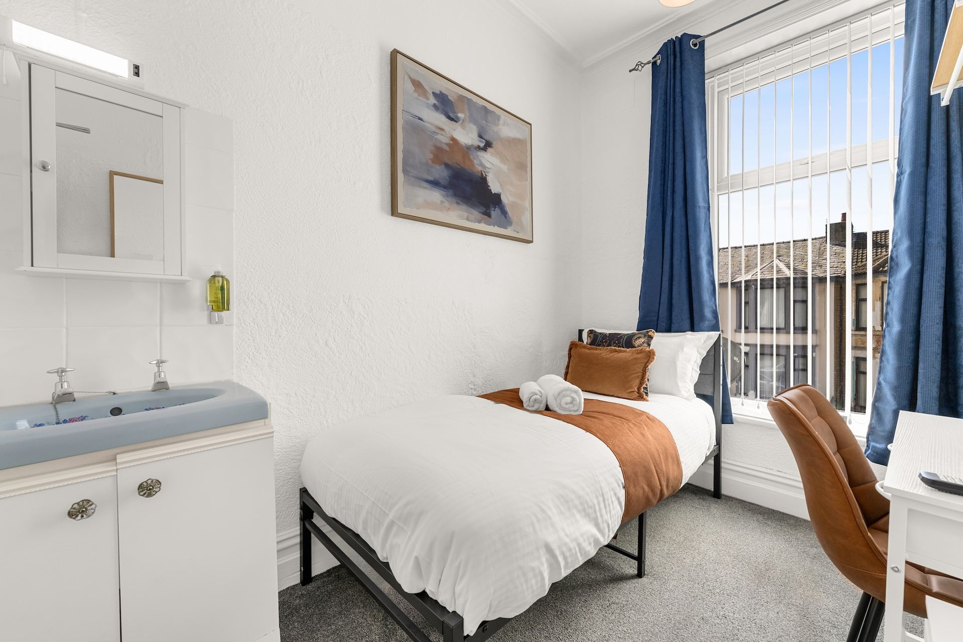 Single room at Ember House with ensuite wash basin and desk